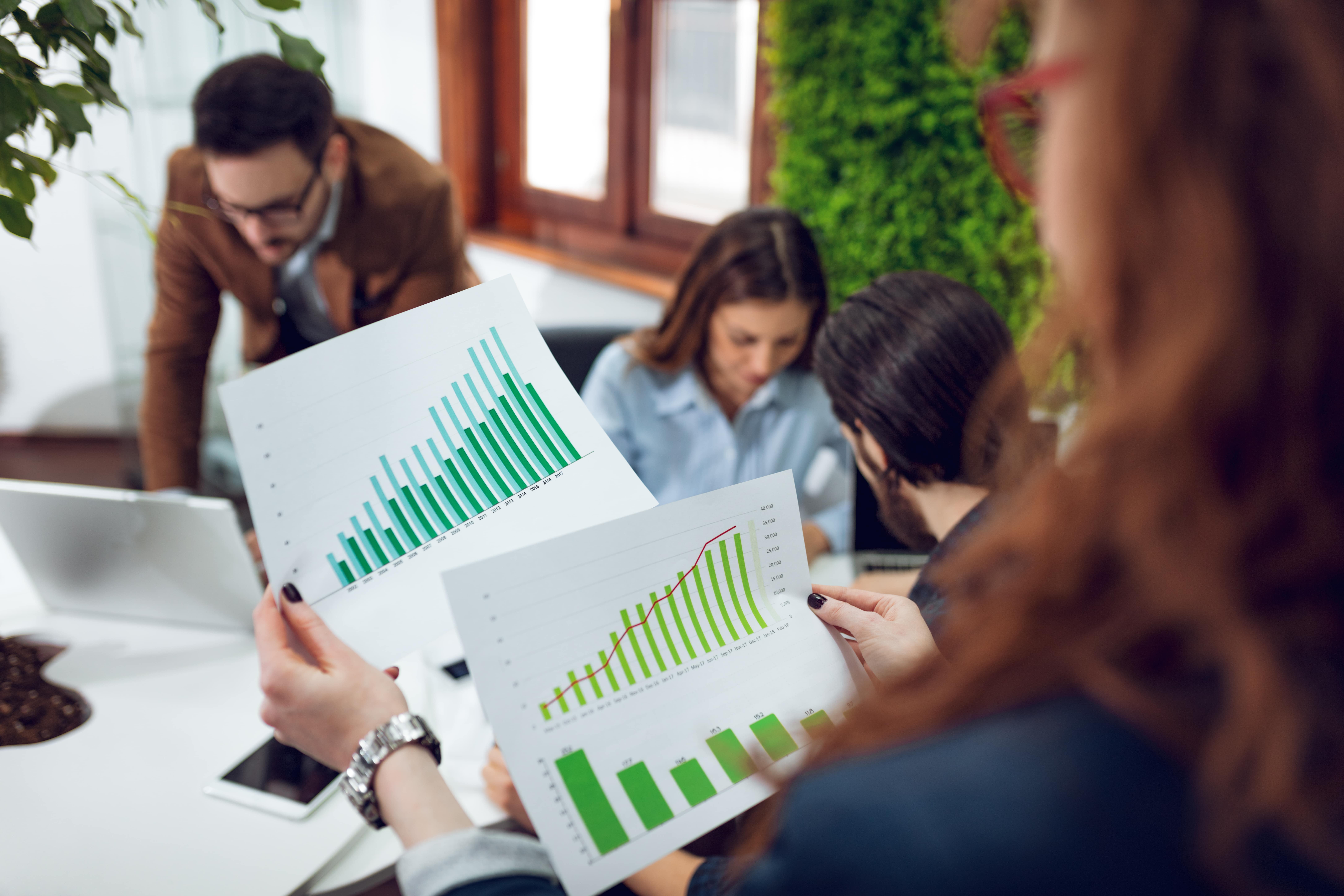 An Image of a Woman holding graphs A woman holding graphs